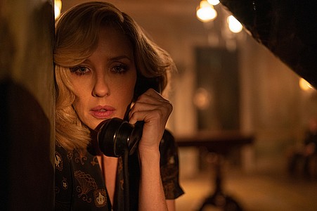 Filmszene: Hausdame Rowena klammert sich an den Hörer ihres Telefons - A Haunting in Venice auf Disney+.